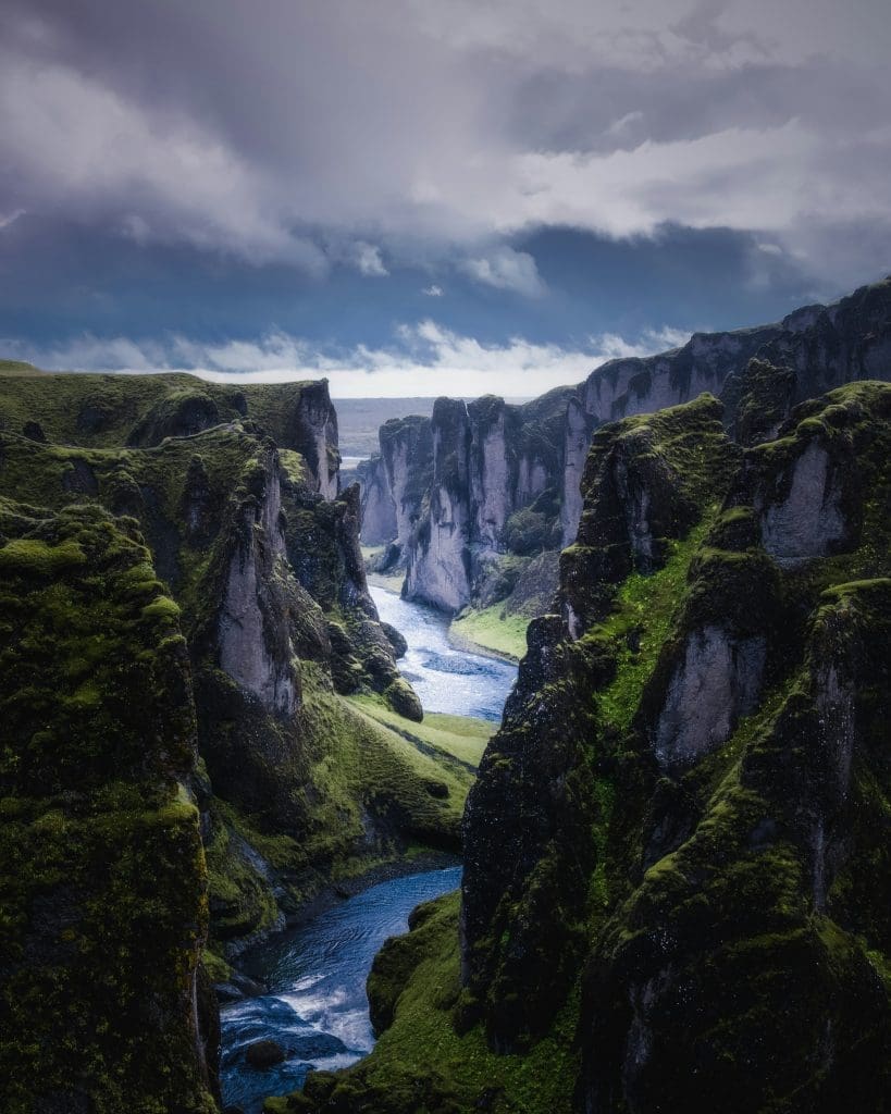 Photo by Cosmic Timetraveler on Unsplash Meandering river flowing through rugged green valley under heavy cloud-laden sky in Iceland