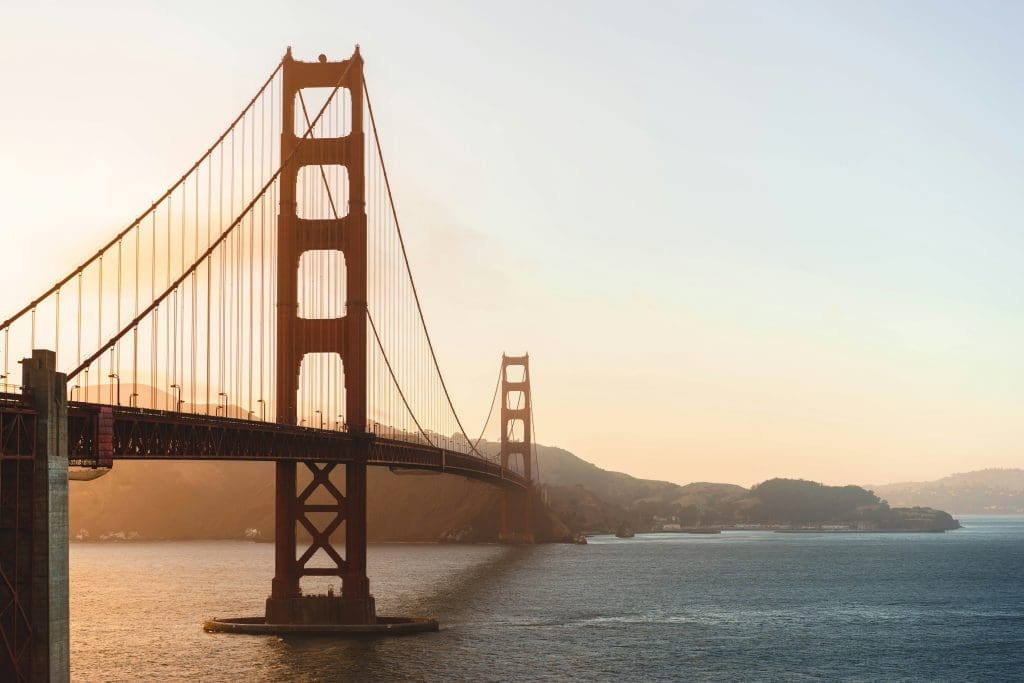 Photo by Michal Pechardo on Unsplash Golden Gate Bridge stretching across San Francisco Bay at sunset with hills in the background